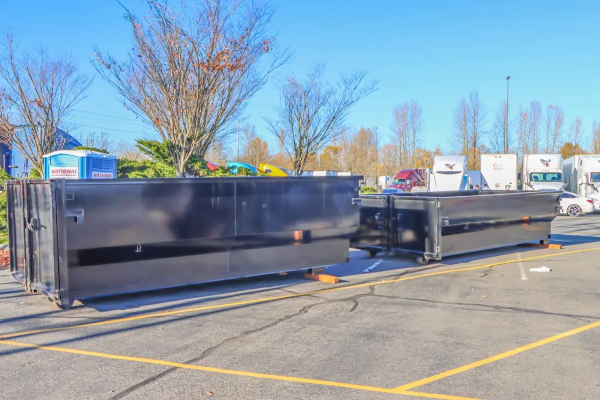 Professional dumpster rental service with roll-off container on residential driveway in Winter Garden